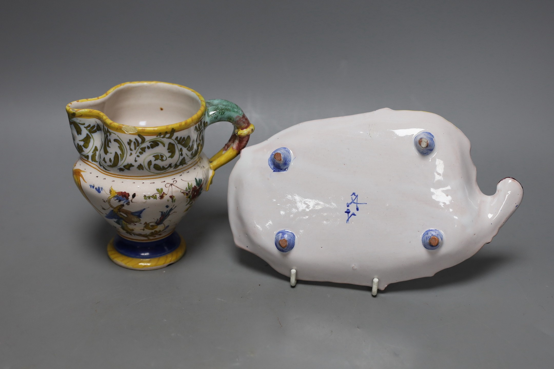 An Italian maiolica pinched beak jug, 12cm tall, and a similar dish